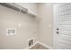 Convenient laundry room with shelving and utility connections at 152 Royal Ave, Selma, NC 27576