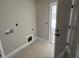 Unfinished laundry room with connections for washer and dryer, plus a doorway to the outside at 152 Royal Ave, Selma, NC 27576