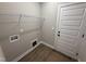 Functional laundry room with shelving and utility connections for washer and dryer at 152 Royal Ave, Selma, NC 27576