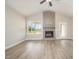 Cozy living room boasts a fireplace, hardwood floors, and neutral color palette at 152 Royal Ave, Selma, NC 27576