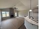 Open-concept living room featuring a vaulted ceiling, fireplace, and access to a deck at 152 Royal Ave, Selma, NC 27576