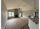 Spacious living room with vaulted ceilings, fireplace, and an open view into the kitchen at 152 Royal Ave, Selma, NC 27576