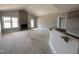 Spacious living room with vaulted ceilings, fireplace, and access to an unfinished kitchen at 152 Royal Ave, Selma, NC 27576