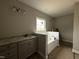 Bright primary bathroom with dual vanities, granite countertops, and a separate tub at 152 Royal Ave, Selma, NC 27576