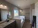 Primary bathroom featuring a soaking tub, double sinks and granite countertops at 152 Royal Ave, Selma, NC 27576