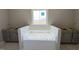 Bright, unfinished bathroom with soaking tub and plenty of natural light at 152 Royal Ave, Selma, NC 27576
