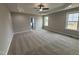 Spacious main bedroom with carpet, a ceiling fan, and a tray ceiling at 152 Royal Ave, Selma, NC 27576