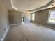 Spacious main bedroom with tray ceiling, natural light, and an ensuite bathroom at 152 Royal Ave, Selma, NC 27576