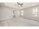 Spacious main bedroom featuring plush carpeting, tray ceiling, and natural light at 152 Royal Ave, Selma, NC 27576