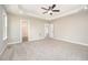 Bright and airy main bedroom with carpeted floors and a walk-in closet entrance at 152 Royal Ave, Selma, NC 27576