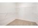 A walk-in closet featuring carpet and multiple wire shelving units for storage at 152 Royal Ave, Selma, NC 27576
