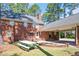Brick home featuring backyard area with picnic table, covered parking, and mature trees at 1602 Lake Shore Dr, Dunn, NC 28334
