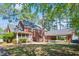 Screened porch, covered parking, and mature trees in a home's private backyard at 1602 Lake Shore Dr, Dunn, NC 28334
