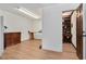 Bright basement with an open doorway leading to a wood-paneled office with built-in shelving at 1602 Lake Shore Dr, Dunn, NC 28334