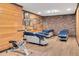 Spacious basement featuring wood-look floors and wood-paneled and brick walls with exercise equipment at 1602 Lake Shore Dr, Dunn, NC 28334