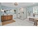 Bright bathroom features a glass shower, soaking tub, modern vanity, and a door to the outside at 1602 Lake Shore Dr, Dunn, NC 28334
