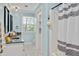 Stylish blue bathroom with patterned tile, dual mirrors, black granite countertop, and a walk-in shower at 1602 Lake Shore Dr, Dunn, NC 28334