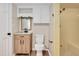 Well-lit bathroom featuring a modern vanity with a wooden cabinet and a retro tiled shower at 1602 Lake Shore Dr, Dunn, NC 28334