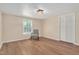 Bedroom with natural light, neutral walls, wood floors, and closet space at 1602 Lake Shore Dr, Dunn, NC 28334