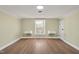 Neutral bedroom with hardwood floors, a large window, and built-in bedside tables at 1602 Lake Shore Dr, Dunn, NC 28334