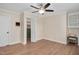 Bedroom with hardwood floors, ceiling fan, built-in desk, and a walk-in closet with shelving at 1602 Lake Shore Dr, Dunn, NC 28334
