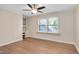 Bright bedroom with hardwood floors, ceiling fan, and a large window offering scenic views at 1602 Lake Shore Dr, Dunn, NC 28334