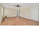 Spacious bedroom with hardwood floors, neutral walls, ceiling fan and ensuite bathroom access at 1602 Lake Shore Dr, Dunn, NC 28334