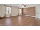 Bedroom features hardwood floors, natural light from two windows, and a ceiling fan at 1602 Lake Shore Dr, Dunn, NC 28334