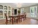 Elegant dining room featuring a crystal chandelier, wood table with seating for eight, and custom built-in shelving at 1602 Lake Shore Dr, Dunn, NC 28334