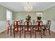 Formal dining room with hardwood floors, chandelier, and elegant furniture at 1602 Lake Shore Dr, Dunn, NC 28334