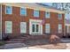 Close-up of the brick facade with a charming entryway, French doors, and manicured landscaping at 1602 Lake Shore Dr, Dunn, NC 28334