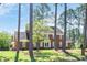 Two-story brick home with mature landscaping, stately trees, and an inviting front entrance at 1602 Lake Shore Dr, Dunn, NC 28334
