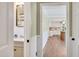 Bright hallway with bathroom and kitchen views features fresh paint and white wainscotting at 1602 Lake Shore Dr, Dunn, NC 28334