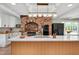 Updated kitchen featuring a large center island, brick oven surround, modern appliances, and ample counter space at 1602 Lake Shore Dr, Dunn, NC 28334