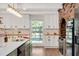 Bright kitchen with white cabinets, butcher block countertops, a subway tile backsplash and updated appliances at 1602 Lake Shore Dr, Dunn, NC 28334