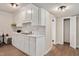 Basement kitchen featuring white cabinetry, wood-look floors, and a stainless steel sink with fixtures at 1602 Lake Shore Dr, Dunn, NC 28334