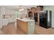 Spacious kitchen boasts an island, modern appliances, custom cabinetry, and a brick feature wall at 1602 Lake Shore Dr, Dunn, NC 28334