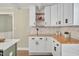 Charming kitchen features white cabinetry, butcher block counters, subway tile backsplash and an open layout at 1602 Lake Shore Dr, Dunn, NC 28334