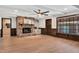 Spacious living room featuring a red brick fireplace, wood floors, and bright natural light at 1602 Lake Shore Dr, Dunn, NC 28334