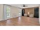 Open living area with two large windows, wood floors, modern furniture, and accent wall at 1602 Lake Shore Dr, Dunn, NC 28334
