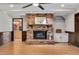Bright living room with brick fireplace, wood floors, and views to the kitchen at 1602 Lake Shore Dr, Dunn, NC 28334