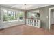 Sunlit dining area with large bay window, stylish chandelier, wood floors, and built in storage at 1602 Lake Shore Dr, Dunn, NC 28334