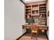 Home office featuring a built-in desk with shelving and a comfortable chair with warm lighting at 1602 Lake Shore Dr, Dunn, NC 28334