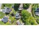 Overhead aerial view of neighborhood with mature trees, backyard, and houses at 1604 Cane Creek Dr, Garner, NC 27529