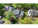 Aerial view of a landscaped backyard with large patio, mature trees, and lush green grass at 1604 Cane Creek Dr, Garner, NC 27529