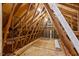 Spacious attic with exposed wooden beams and ample storage space at 1604 Cane Creek Dr, Garner, NC 27529