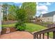 Lush backyard with a patio and wooden deck, perfect for outdoor gatherings and enjoying the natural surroundings at 1604 Cane Creek Dr, Garner, NC 27529