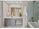 Modern bathroom with a mosaic-tiled shower, sleek vanity, and a large mirror, providing a stylish space at 1604 Cane Creek Dr, Garner, NC 27529