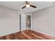 Bright bedroom with wood floors, ceiling fan, and closet access at 1604 Cane Creek Dr, Garner, NC 27529