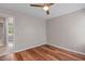 Bright bedroom with hardwood floors and access to the bathroom at 1604 Cane Creek Dr, Garner, NC 27529
